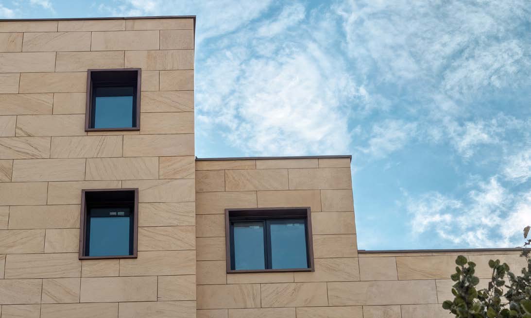 CLADLITE Natural Sandstone finish CL-NS-01 on a punched-window façade